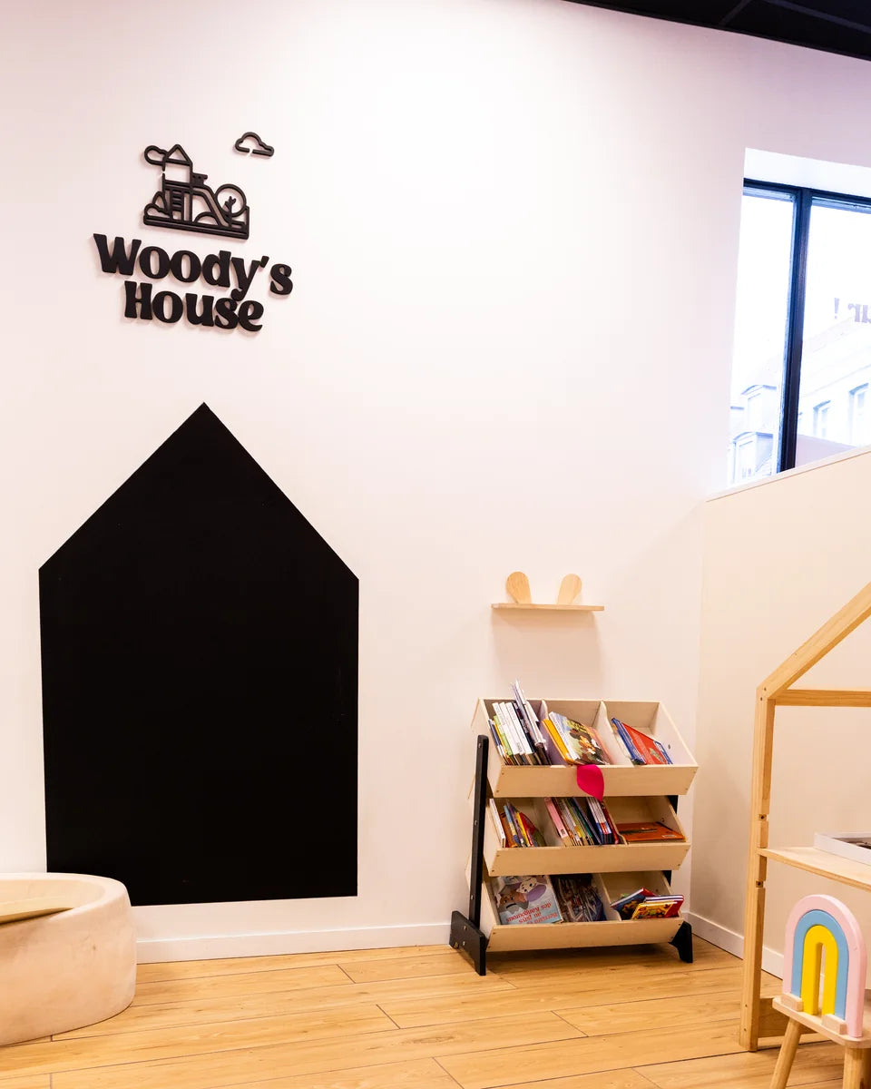 Espace enfants Woody's House de Woody's Factory Douai : mur en tableau à craie, livres et petit bureau en bois